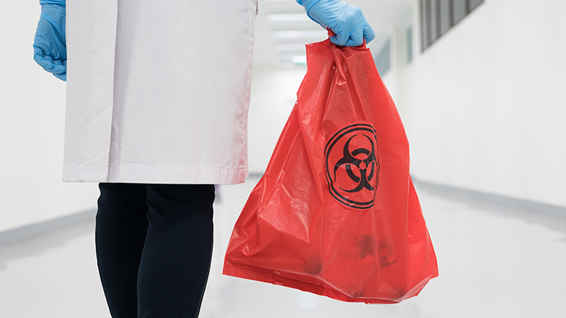 Worker disposing of medical waste